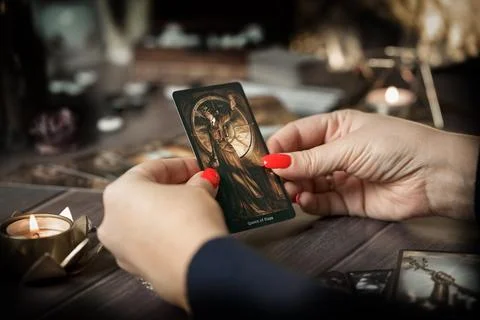 Tarot card reader arranges cards in a card spread. Fortune-telling concept Stock Photos