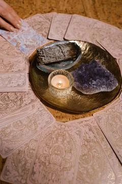 Tarot card reading session with crystals and candles on a wooden table in a.. Stock Photos