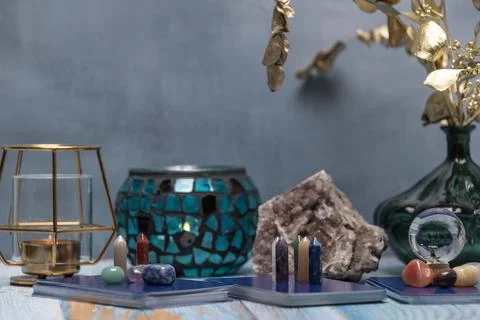 A tarot card reading setup with an array of colorful healing crystals on a .. Stock Photos