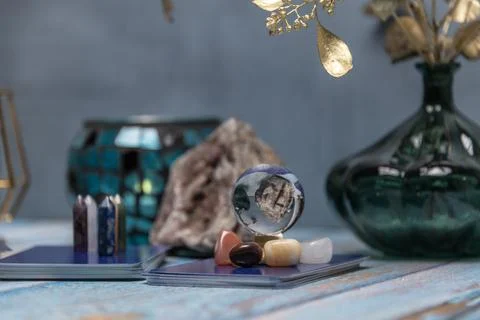 A tarot card reading setup with an array of colorful healing crystals on a .. Stock Photos