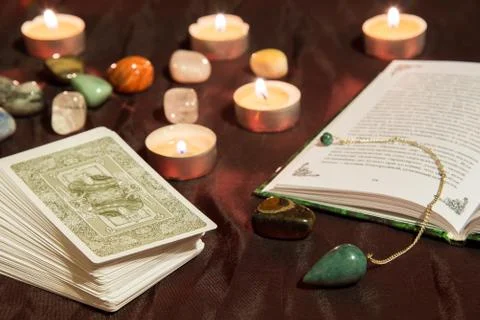 Tarot cards with book and pendulum Stock Photos