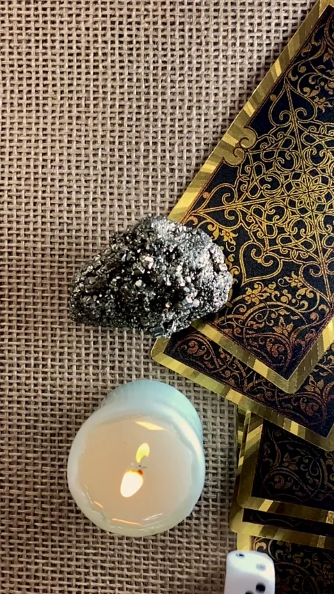 Tarot cards, candlelight, and dice create a mystical scene Stock Footage 312822772