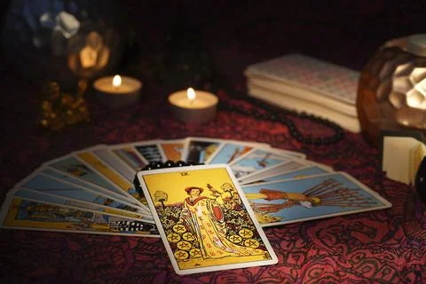 Tarot cards layout on witch table. Nine of Coins Pentacles. Stock Photos