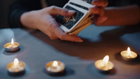 Tarot Cards Lie on Table Next to Burning Candles 動画素材 300829970