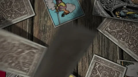 Tarot Decks Falling on a Wooden Table. Cards revelation. Five of Wands. Close Up Stock Footage