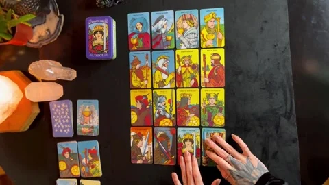 A tarot reader arranging her cards on the table Stock Footage 249837409