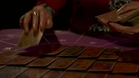 Tarot reader dealing cards &amp; reading future and fortune Stock Footage 76689234