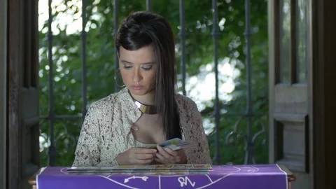 Tarot reader dealing cards &amp; reading future and fortune Stock Footage 76710065