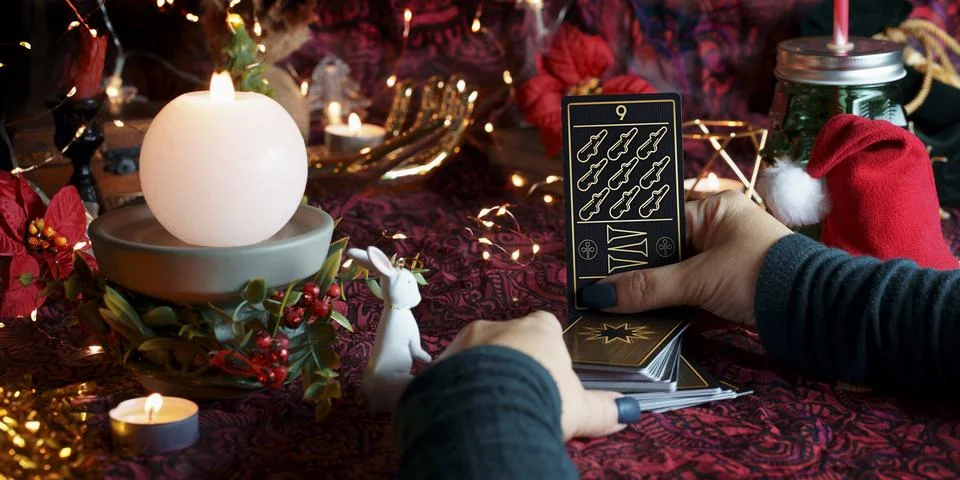 Tarot reader or Fortune teller reading on Christmas decoration. Stock Photos
