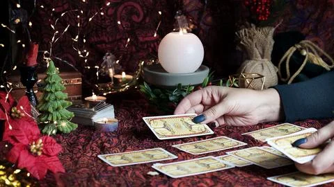 Tarot reader or Fortune teller reading on Christmas decoration. Stock Photos