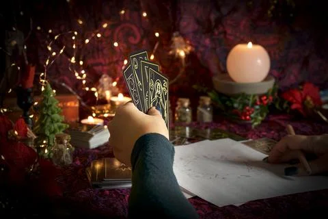 Tarot reader or Fortune teller reading on Christmas decoration. Stock Photos