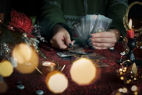 Tarot reader or Fortune teller reading on Christmas decoration. Stock Photos