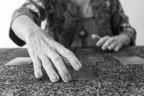 Tarot reader presenting the cards, poised to uncover the secrets they hold Stock Photos