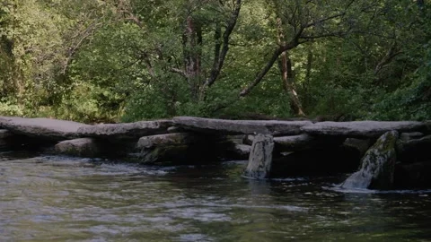 Tarr Steps during daylight capturing the historic clapper bridge and its Stock-Footage 343897971