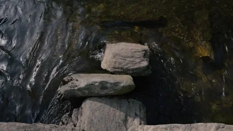Tarr Steps from a low angle, emphasizing the scale and texture of the stone Stock Footage 343899024