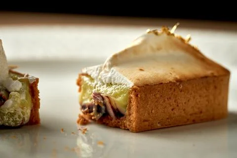 Tart with custard in a plate. Close-up. Selective focus. Noise added in post- Stock Photos