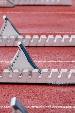 Tartan running track for athletic events with starting blocks Stock Photos