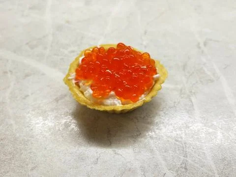 Tartlet topped with red caviar. Stock Photos