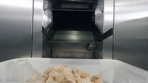 Tartlets fall out from conveyor chamber onto products heap Stock Footage 124892489