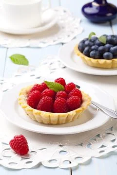 Tartlets with raspberries Stock Photos