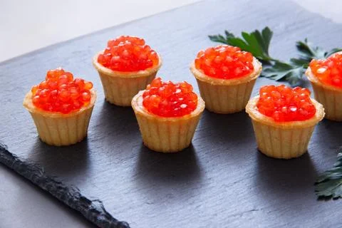 Tartlets with red caviar. Selective focus, space for text . serve red caviar Stock Photos