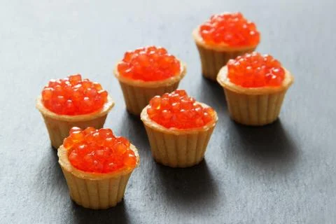 Tartlets with red caviar. Selective focus, space for text . serve red caviar Stock Photos
