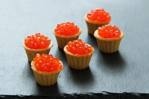 Tartlets with red caviar. Selective focus, space for text . serve red caviar Stock Photos