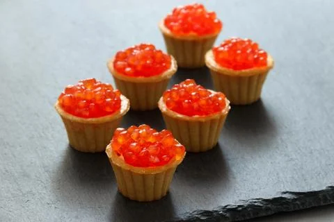 Tartlets with red caviar. Selective focus, space for text . serve red caviar Stock Photos