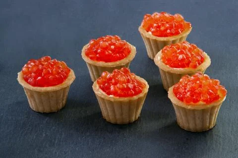 Tartlets with red caviar. Selective focus, space for text . serve red caviar Stock Photos