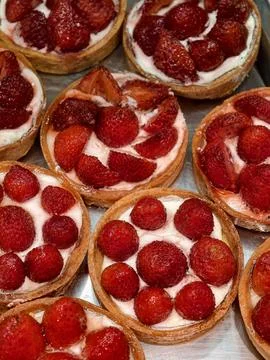 Tartlets with red strawberries feature a delicate pastry base and fresh fru.. Stock Photos