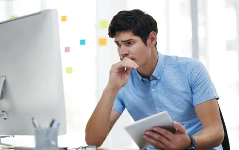 This task really requires all my brainpower. a young businessman looking Stock Photos