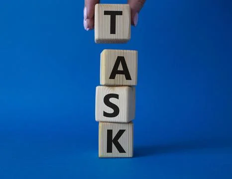 Task symbol. Concept word Task on wooden cubes. Businessman hand. Beautiful.. Stock Photos