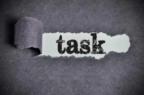 Task word under torn black sugar paper Stock Photos