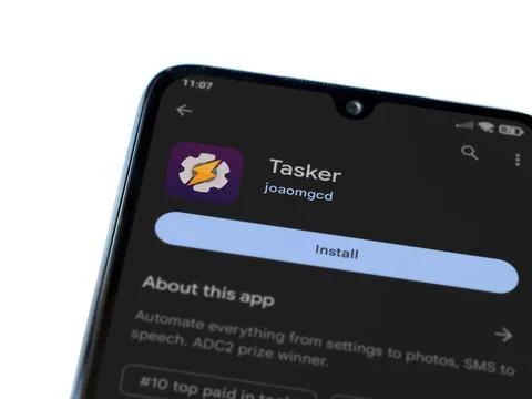 Tasker app play store page on smartphone on white background Stock Photos