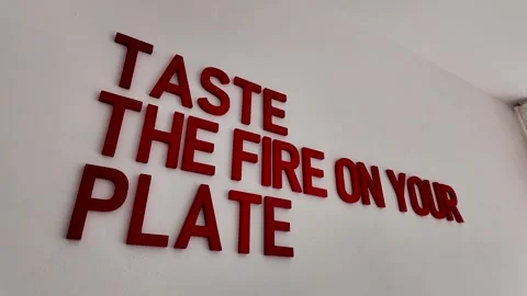 Taste The Fire On Your Plate Red 3D Typography Sign Stock Footage 338371604