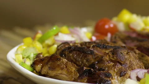 Tasting a beef steak plate with sauce and salad, close up Stock Footage 135479396