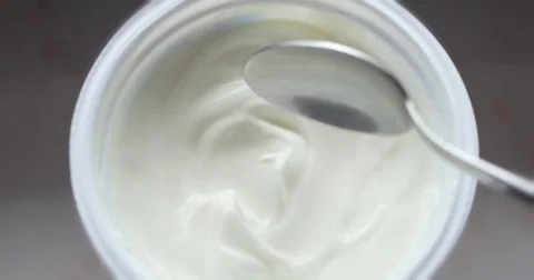 Tasting greek yogurt with spoon Stock Footage