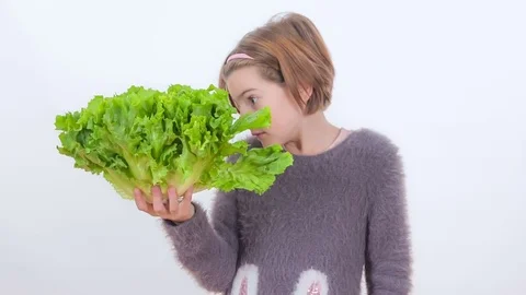 Tasting lettuce and not being very fond of it Stock Footage 83724475