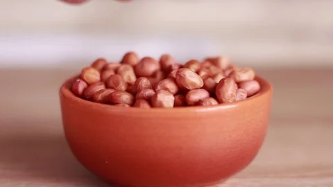 Tasting peanuts from the ceramic pot 動画素材 81584474