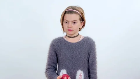 Tasting a red apple and not liking it very much Stock Footage 83724701