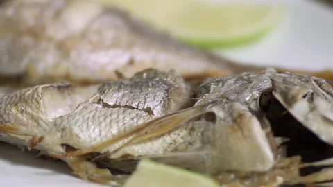 Tasting a roasted fish with lemon, close up Stock Footage 135194449