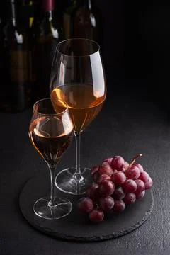 Tasting two types of rose wine with fresh grapes Stock Photos