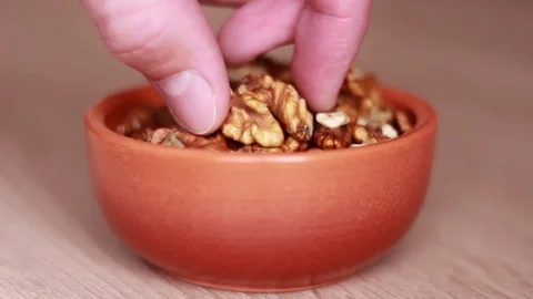 Tasting walnuts from the ceramic pot 動画素材 81584533