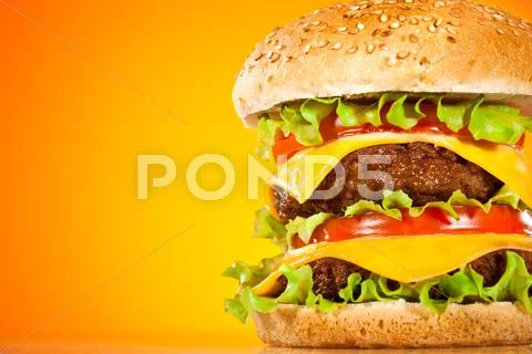 Tasty and appetizing hamburger on a yellow Stock Photos