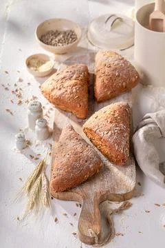 Tasty and brown triangular rolls in rustic bakehouse. Stock Photos