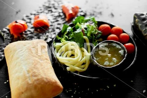Tasty and healthy food. Black background, handmade pottery. Table with delicious Stock-Fotos
