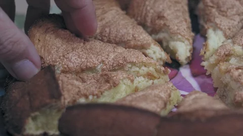 Tasty appetizing pie cut into pieces in a plate on the table closeup Stock Footage 128348666