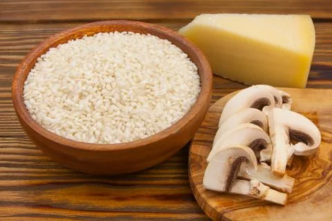 Tasty appetizing risotto on  white plate on  wooden table Stock Photos