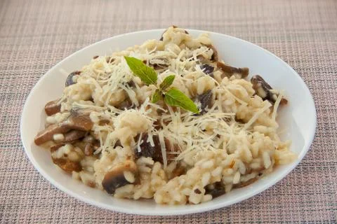 Tasty appetizing risotto on  white plate on  wooden table Stock Photos