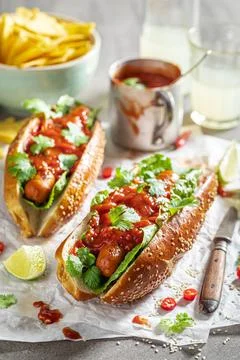 Tasty barbecue hot dogs served with lemonade and nachos. Stock Photos